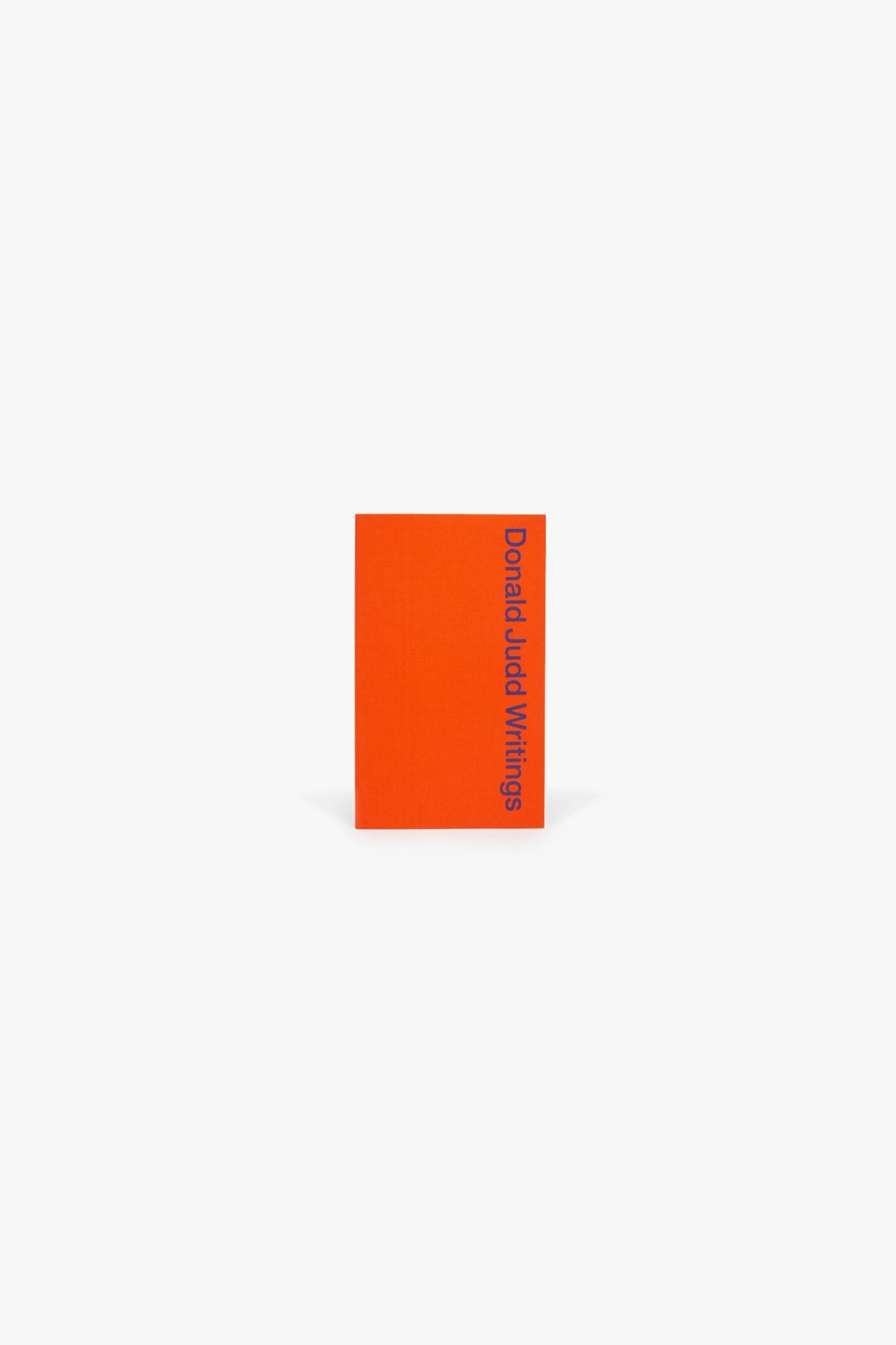 Cover of Judd Foundation’s “Donald Judd Writings.” A red silkscreened cover, with the title running vertically down the right-hand edge.