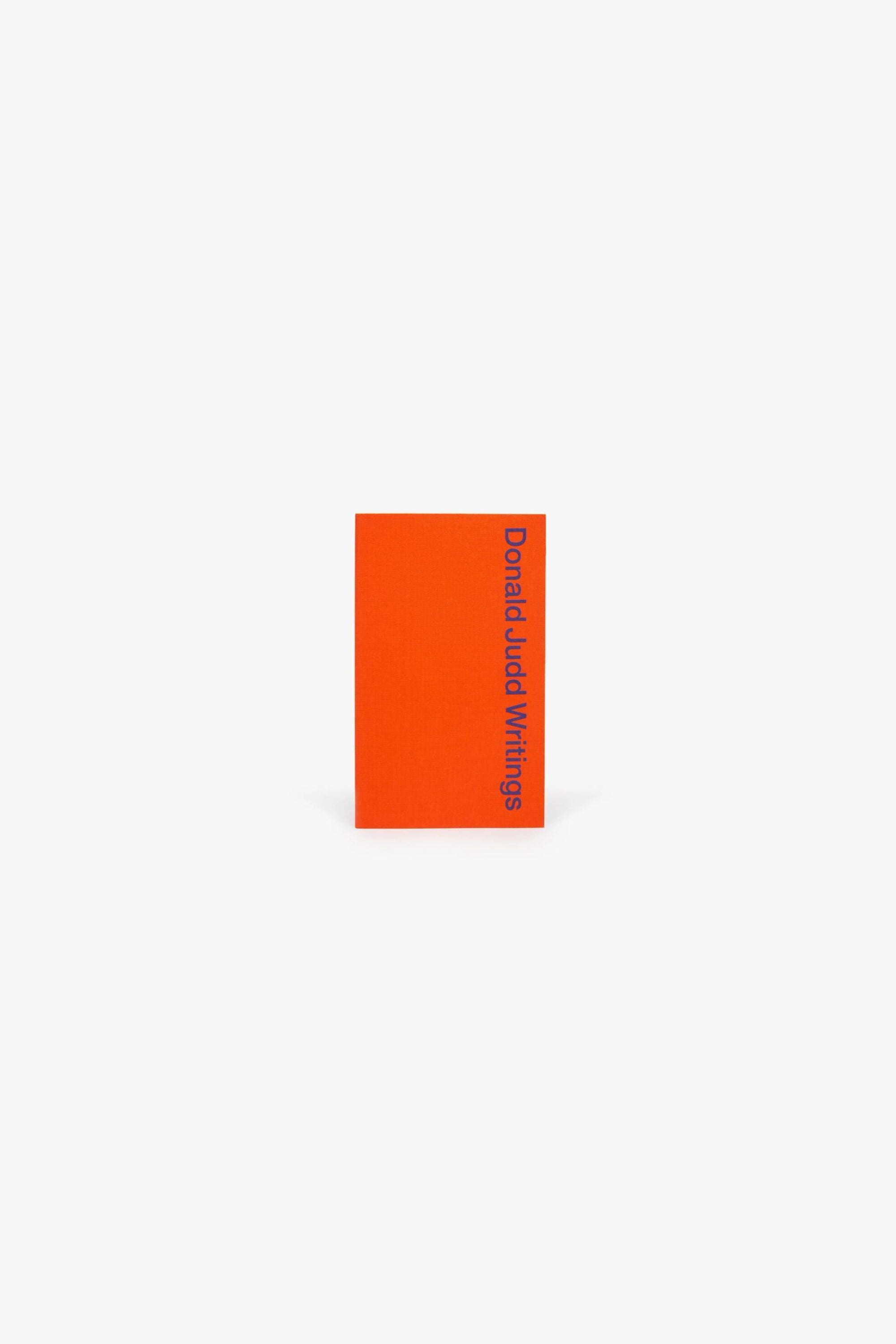 Cover of Judd Foundation’s “Donald Judd Writings.” A red silkscreened cover, with the title running vertically down the right-hand edge.